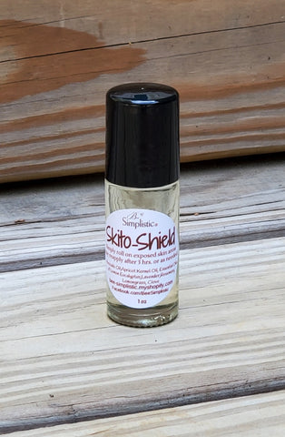 A one ounce glass bottle with a roll-on applicator and black top cap, contains a pleasant smelling blend of essential oils. These oils are of a lovely scent that mosquitoes don't like. Bottle is sitting on weathered wood with weathered wood background.